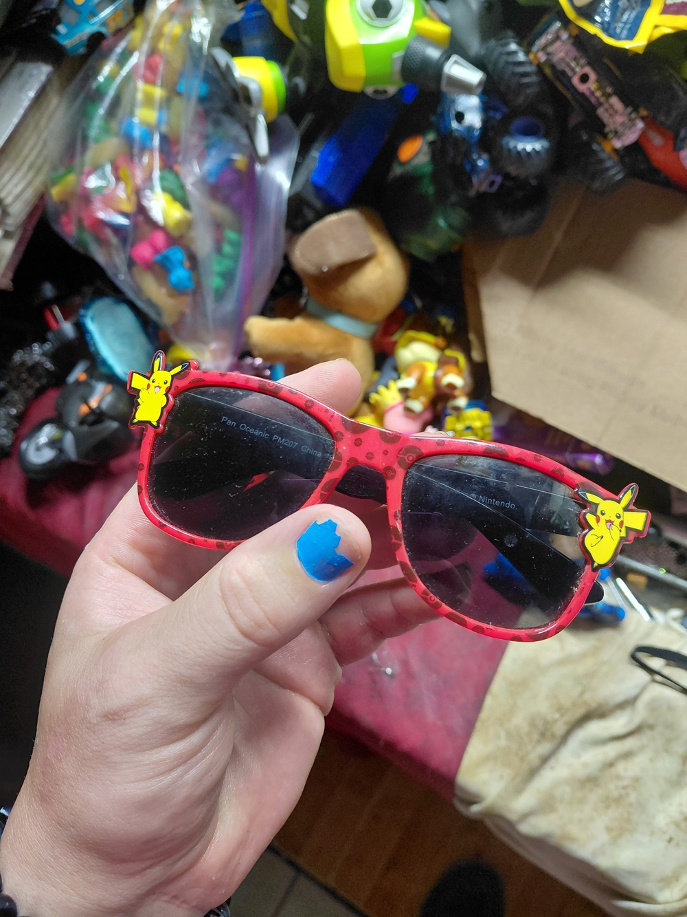 Nintendo Pokémon Pikachu sunglasses feature a red frame with a Poké Ball pattern